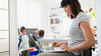 A young woman works on her laptop.